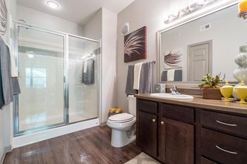A bathroom with a toilet, sink, and shower.